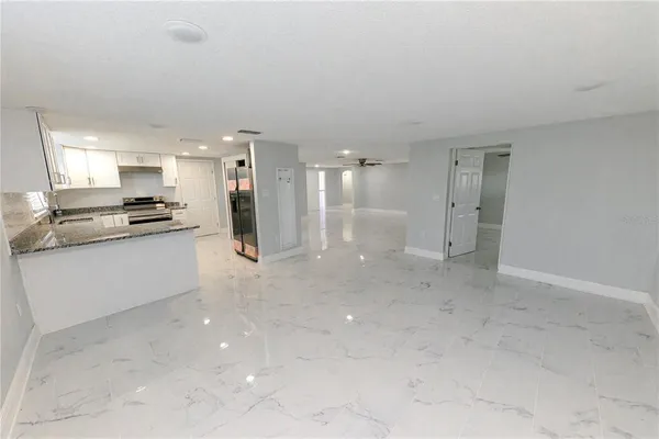 an empty room with windows and closet