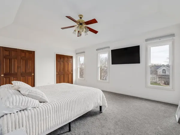 a bedroom with a large bed and a flat screen tv
