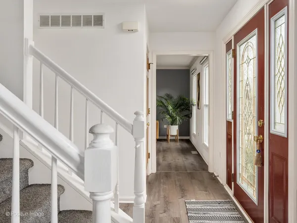 a view of entryway and hall with wooden floor