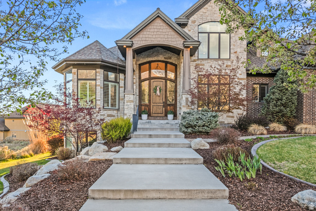 1205 North Elk Rdg Lane, Unit 202 Alpine, UT 84004 - Photo 1 of 88 Stone and brick exterior with a prominent arched entry and decorative wood door