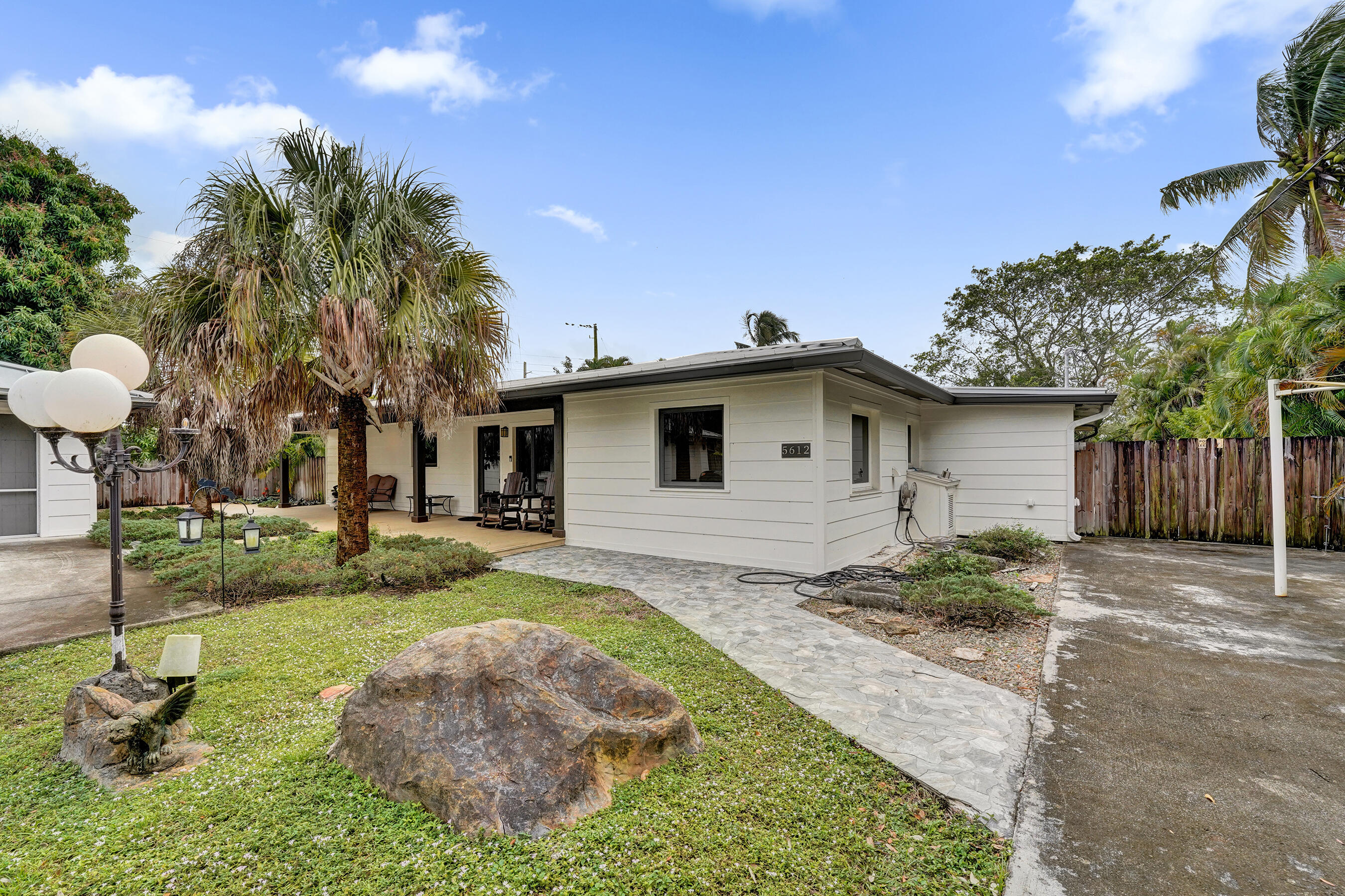 a view of a house with backyard and sitting area
