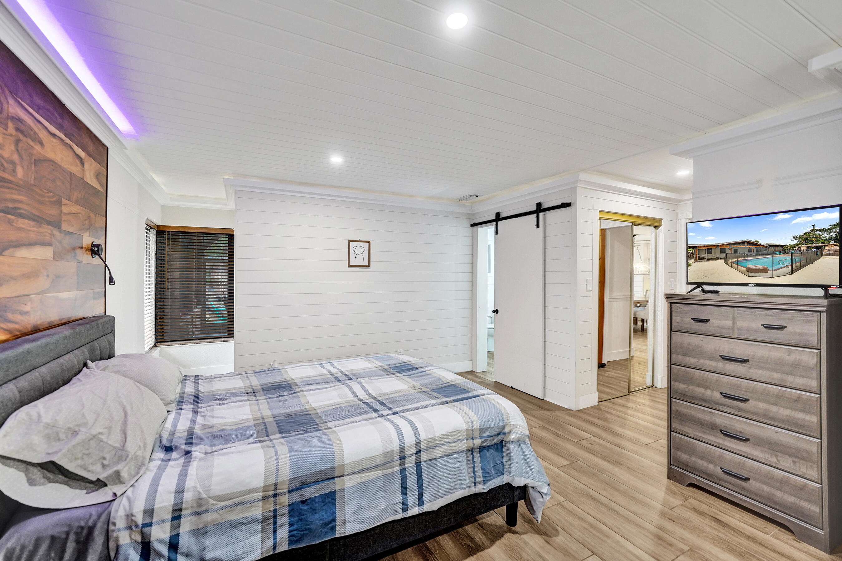 5612 Harding Street Hollywood, FL 33021 - Photo 42 of 52 a bedroom with a bed and a dresser