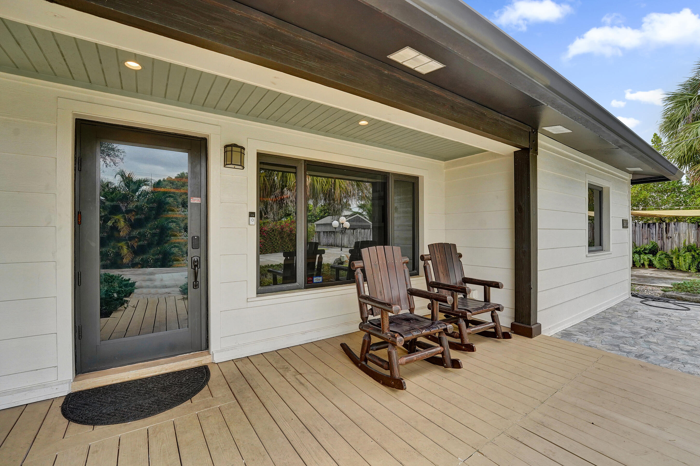 5612 Harding Street Hollywood, FL 33021 - Photo 49 of 52 a view of a patio with table and chairs and potted plants with wooden floor and fence