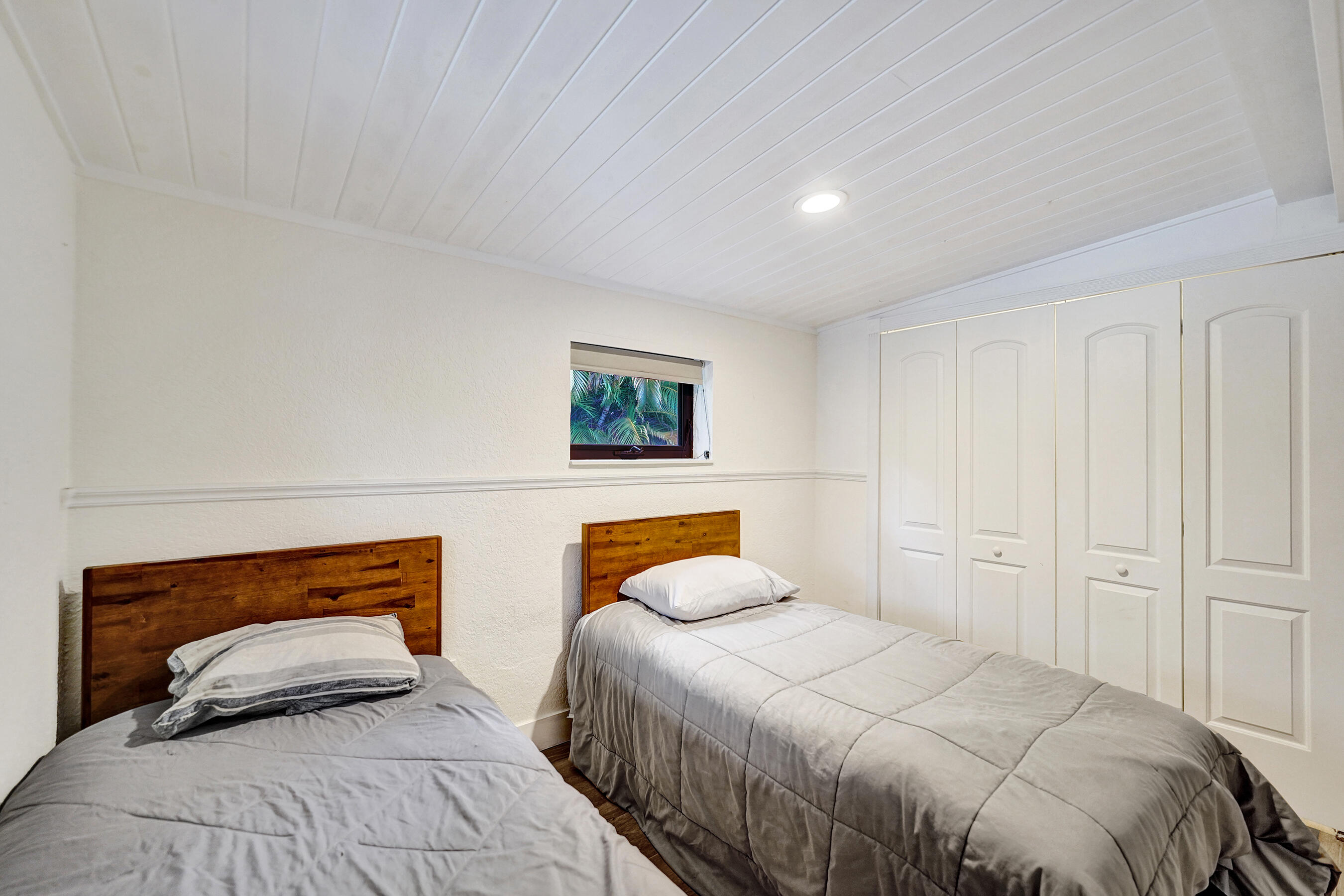 5612 Harding Street Hollywood, FL 33021 - Photo 51 of 52 a bedroom with two beds and a lamp on dresser