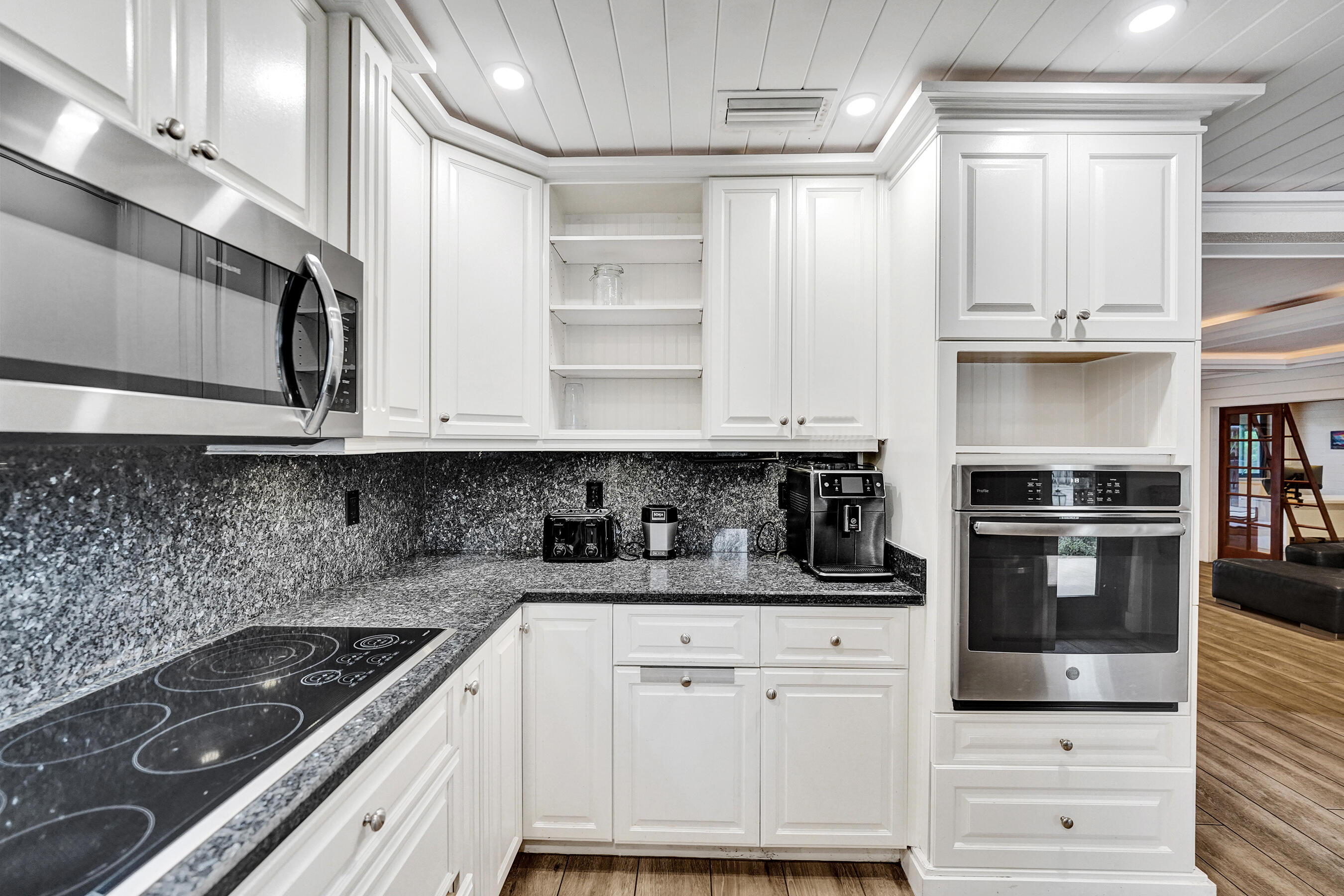 5612 Harding Street Hollywood, FL 33021 - Photo 6 of 52 a kitchen with white cabinets and appliances