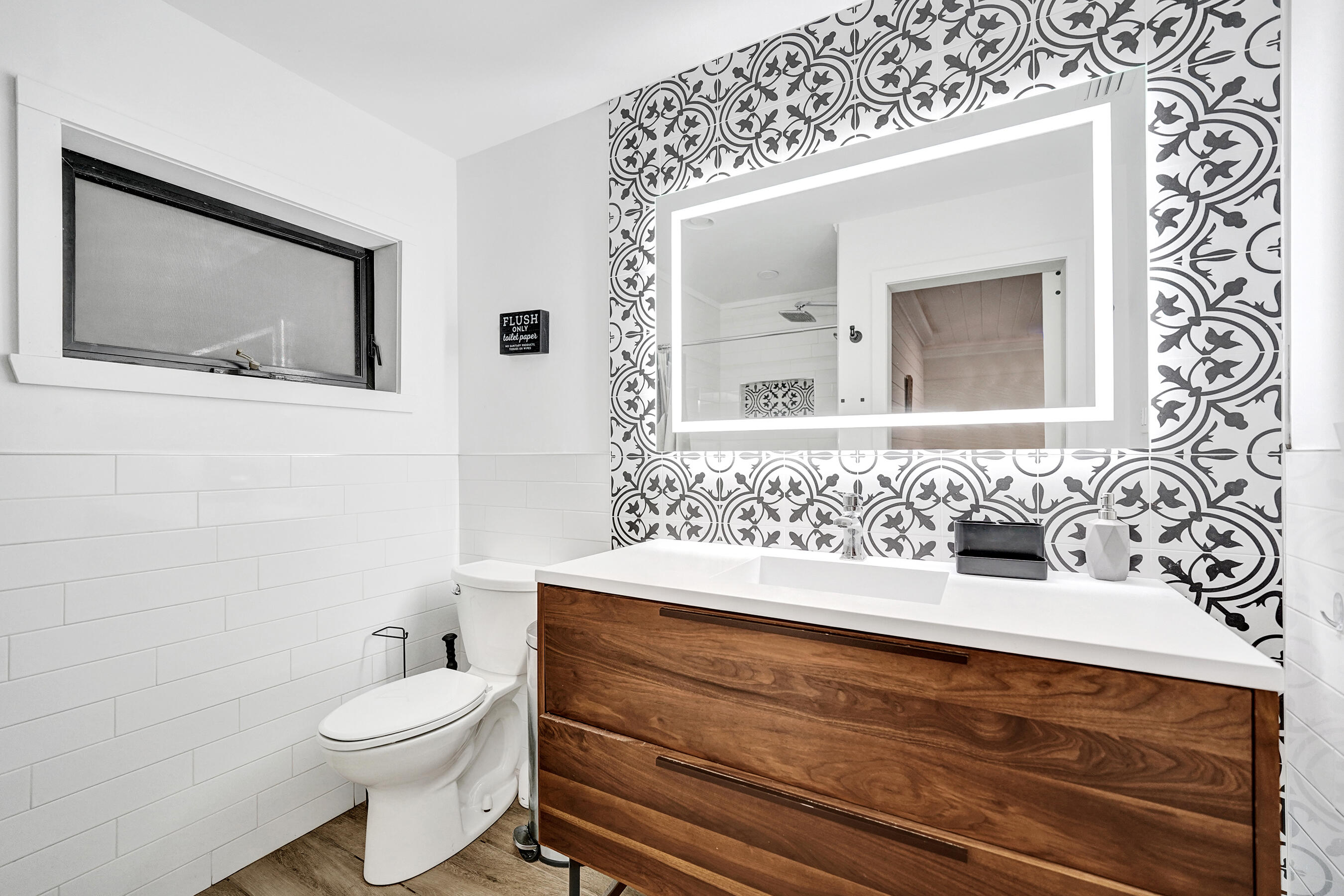 5612 Harding Street Hollywood, FL 33021 - Photo 8 of 52 a bathroom with a toilet a sink and mirror