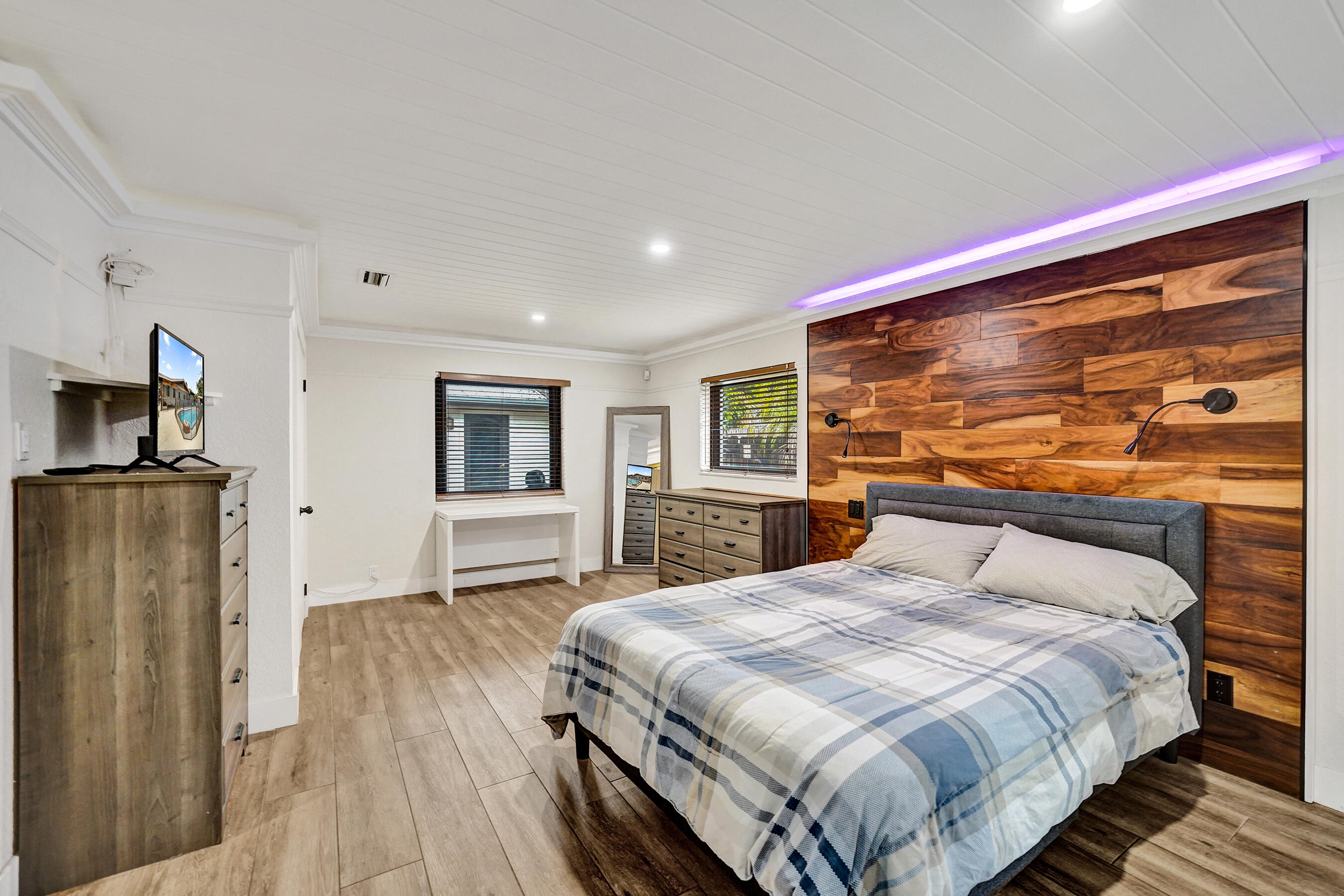 5612 Harding Street Hollywood, FL 33021 - Photo 10 of 52 a bedroom with a large bed and a tv