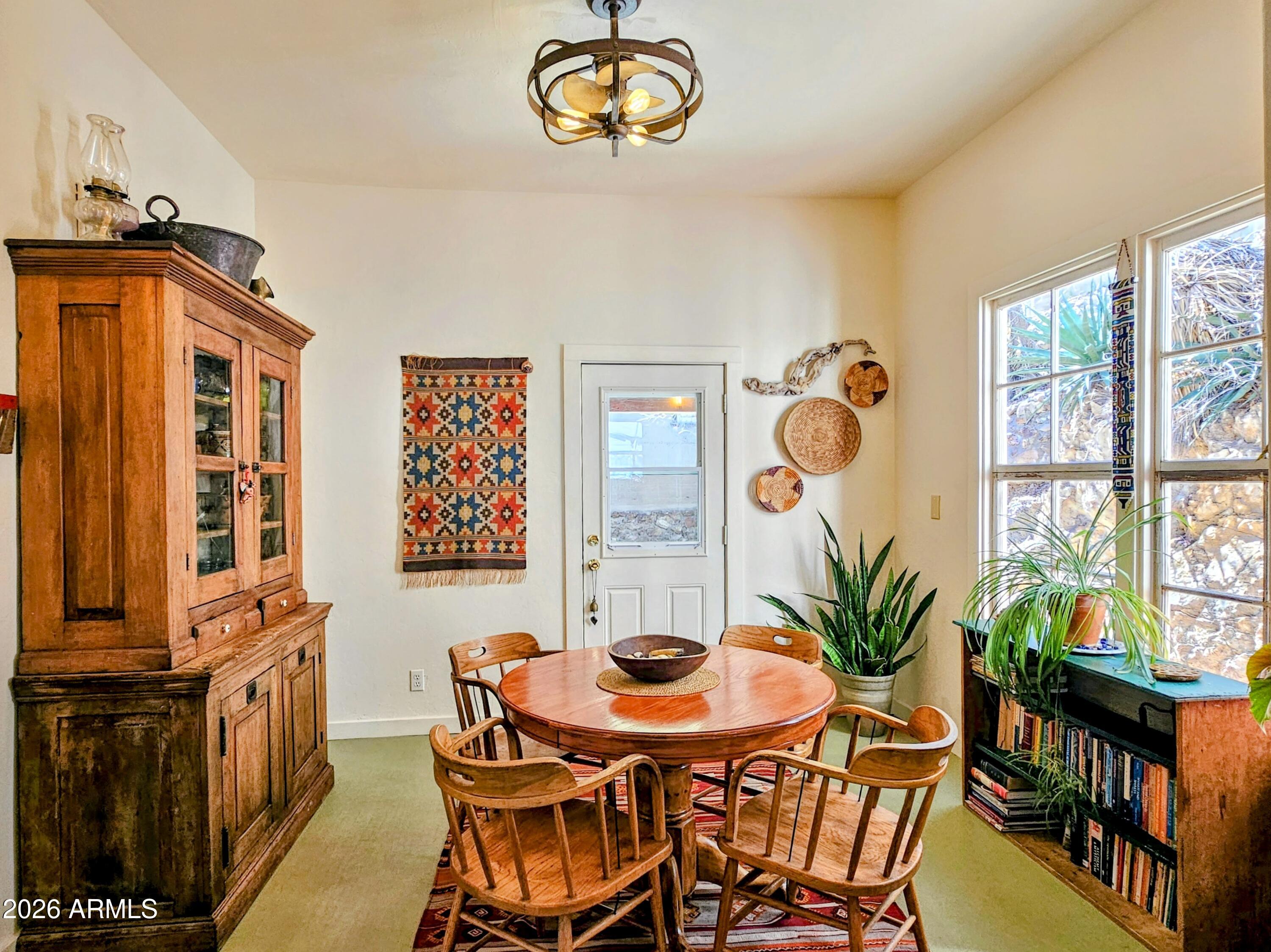 138 B Opera Drive Bisbee, AZ 85603 - Photo 12 of 34 a view of a dining room with furniture a potted plant and a chandelier