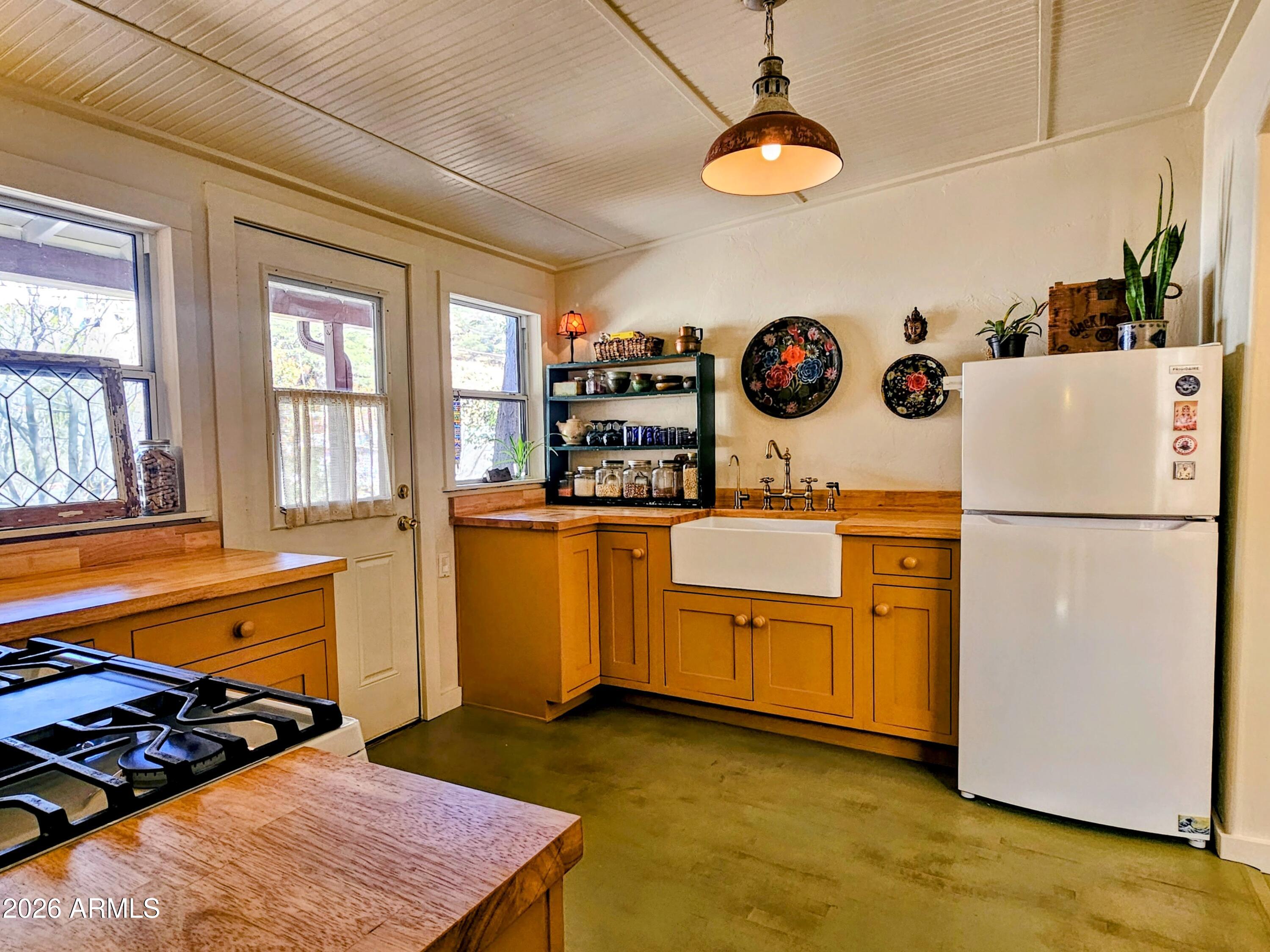 138 B Opera Drive Bisbee, AZ 85603 - Photo 15 of 34 a kitchen with white cabinets and appliances