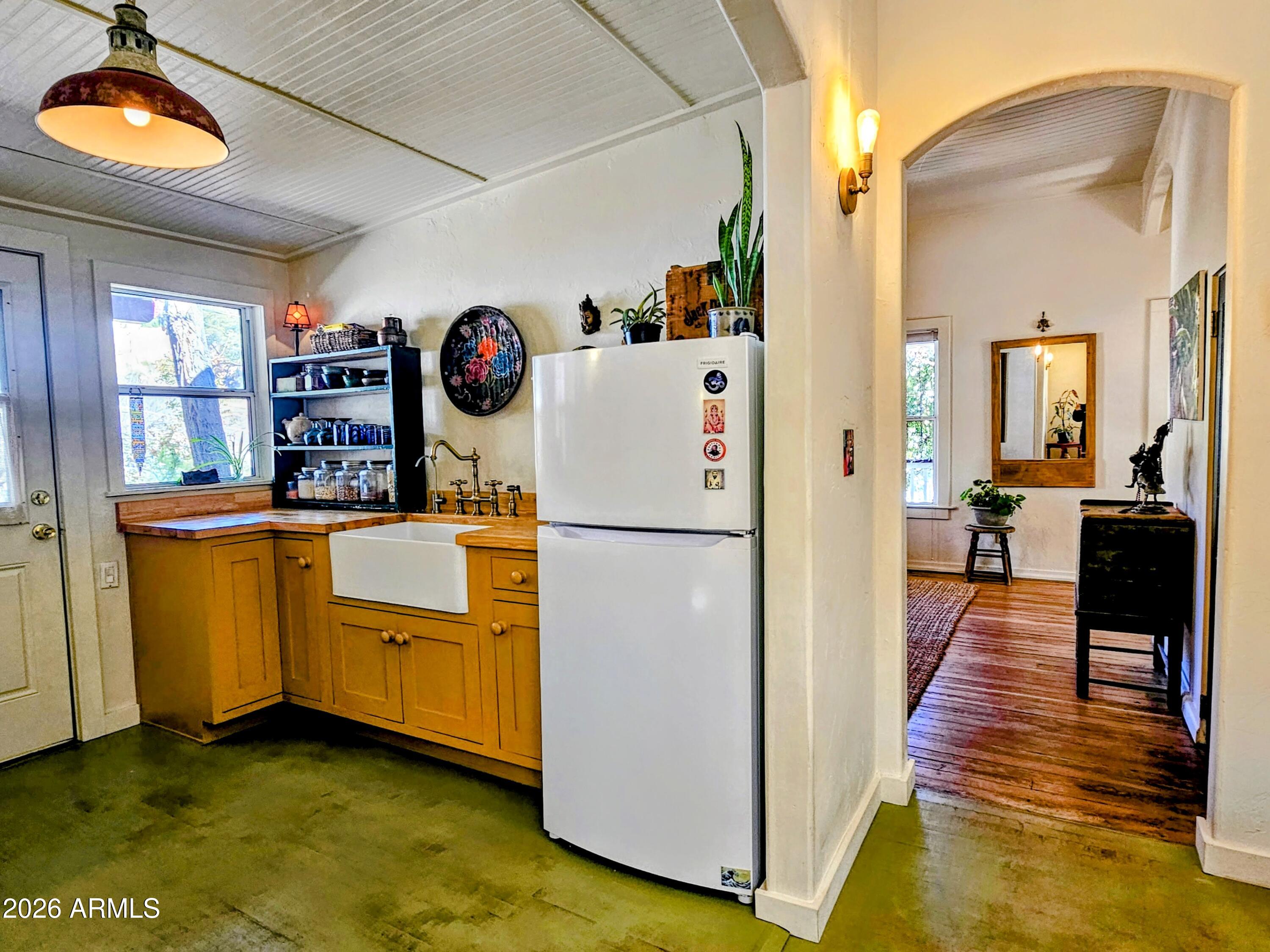 138 B Opera Drive Bisbee, AZ 85603 - Photo 17 of 34 a kitchen with stainless steel appliances a refrigerator sink and wooden floor