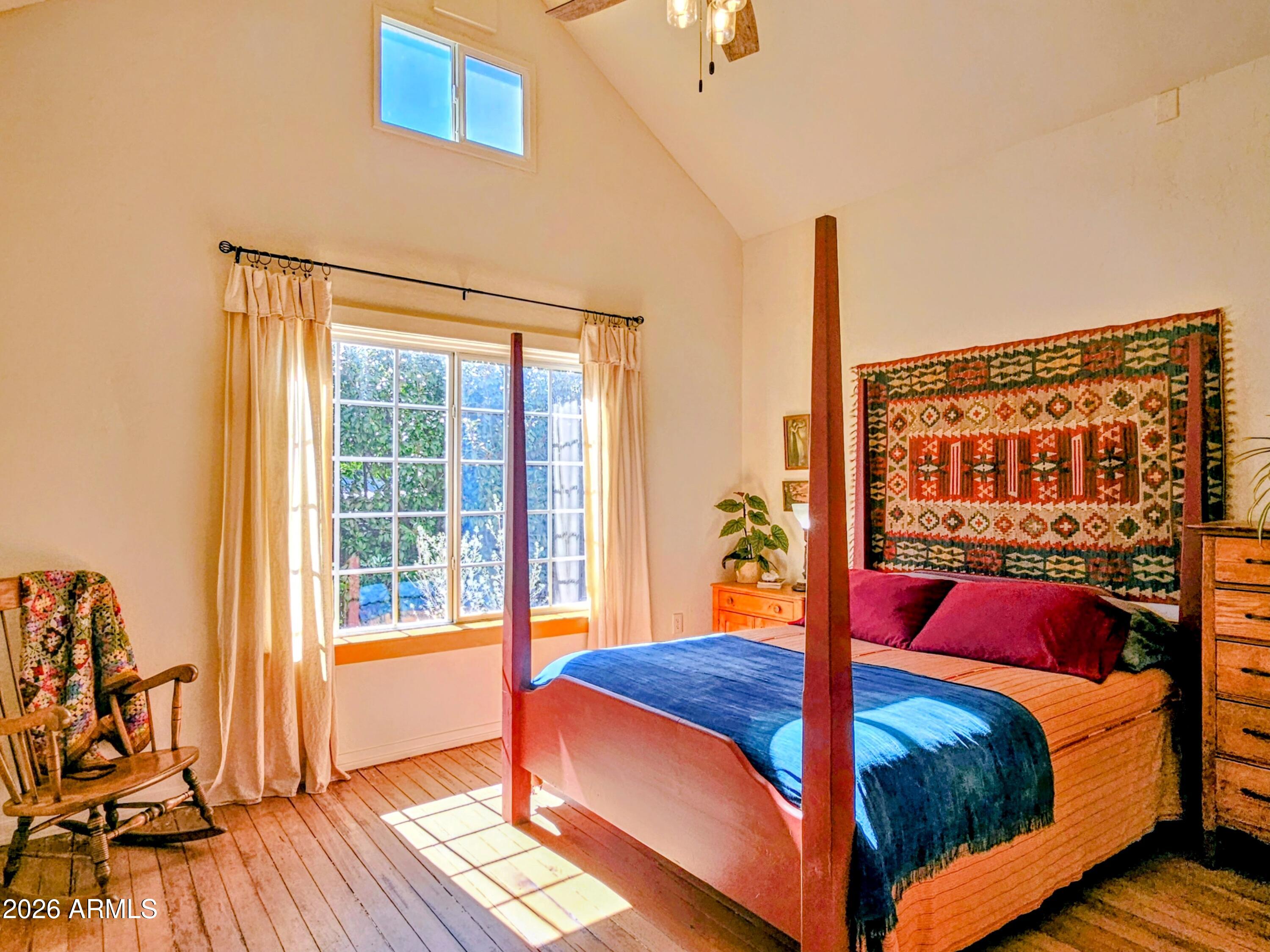 138 B Opera Drive Bisbee, AZ 85603 - Photo 18 of 34 a bedroom with a bed and wooden floor