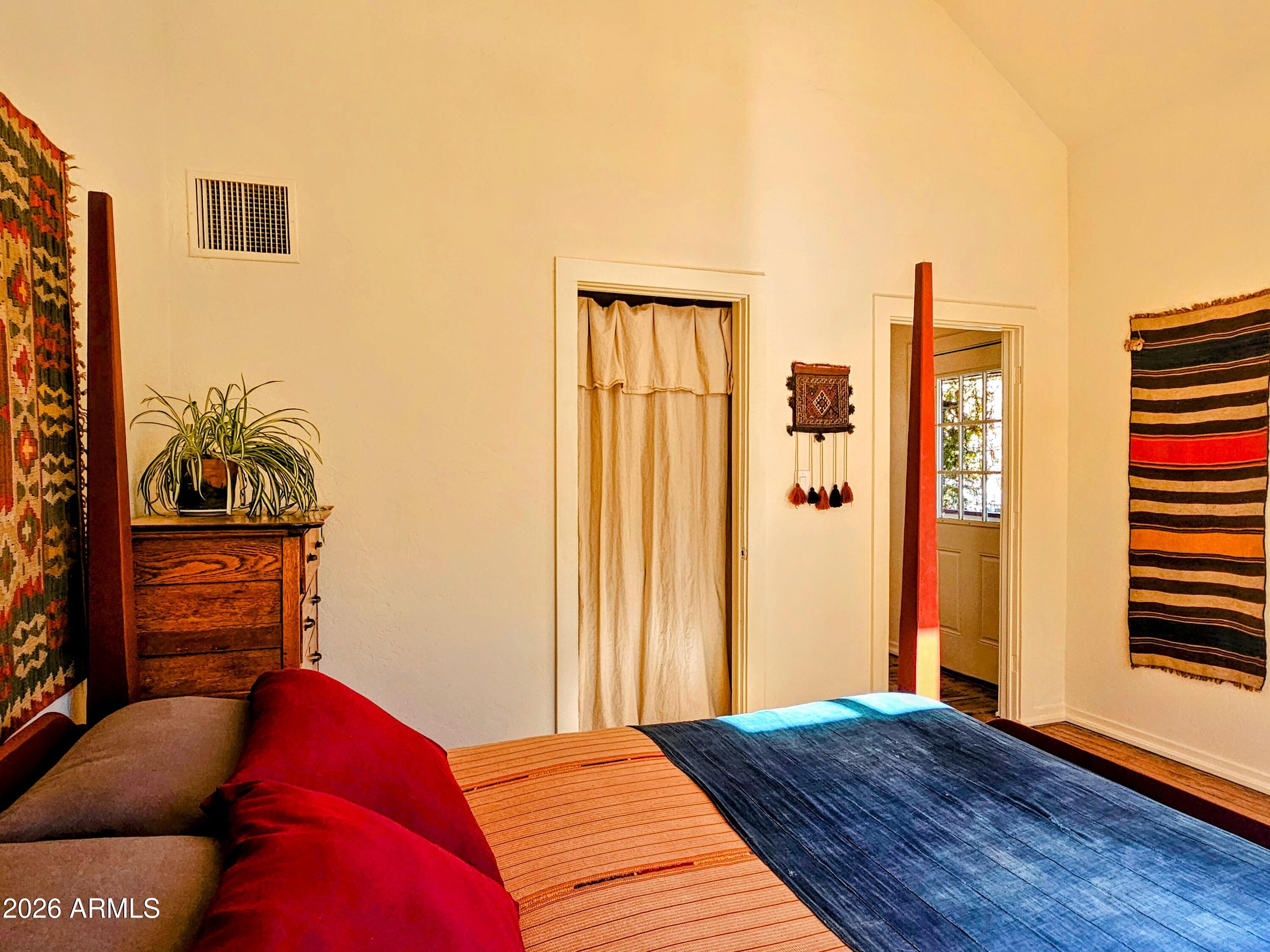 138 B Opera Drive Bisbee, AZ 85603 - Photo 19 of 34 a bedroom with a bed and wooden floor