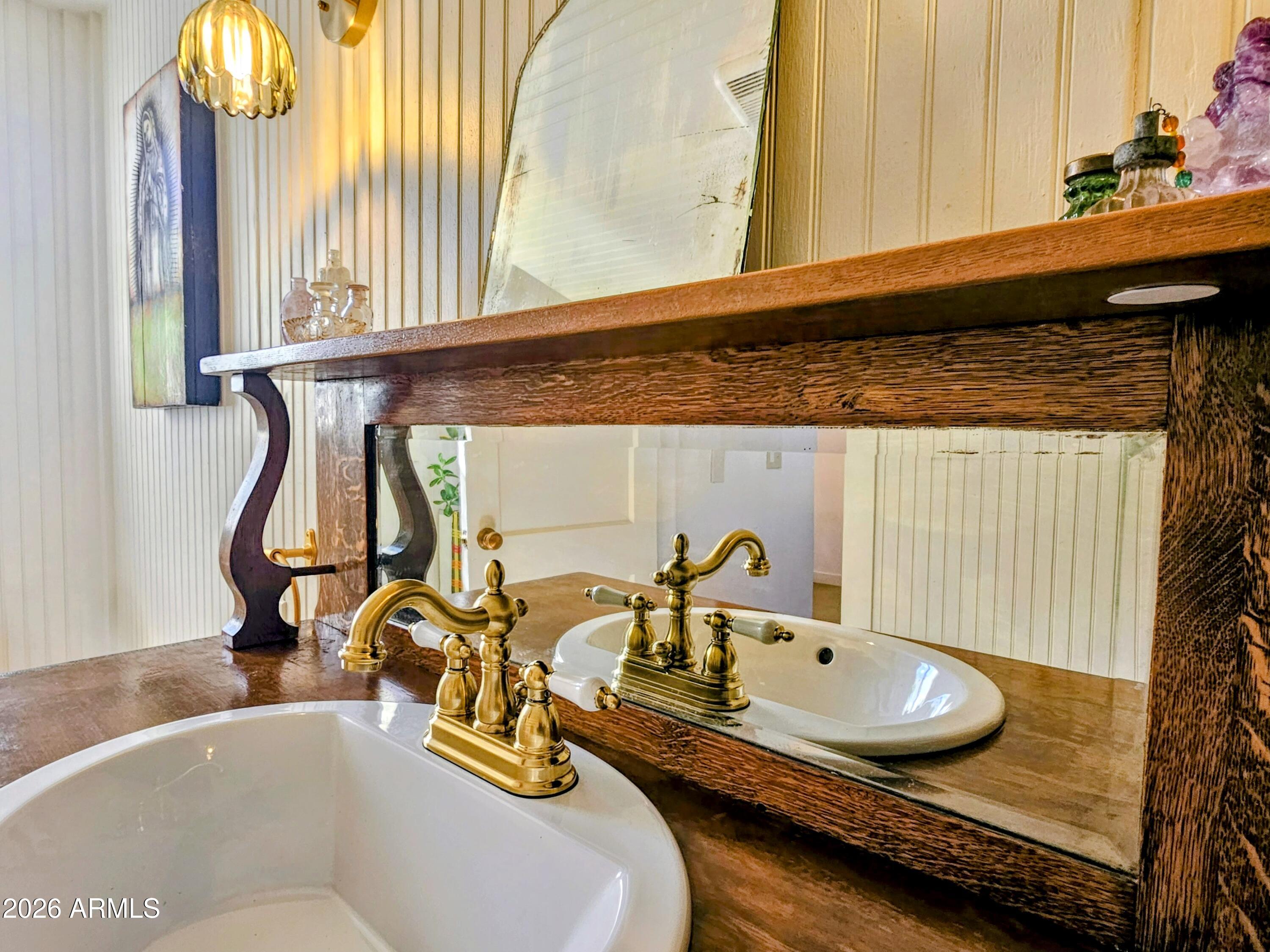 138 B Opera Drive Bisbee, AZ 85603 - Photo 23 of 34 a bathroom with a granite countertop sink and a mirror