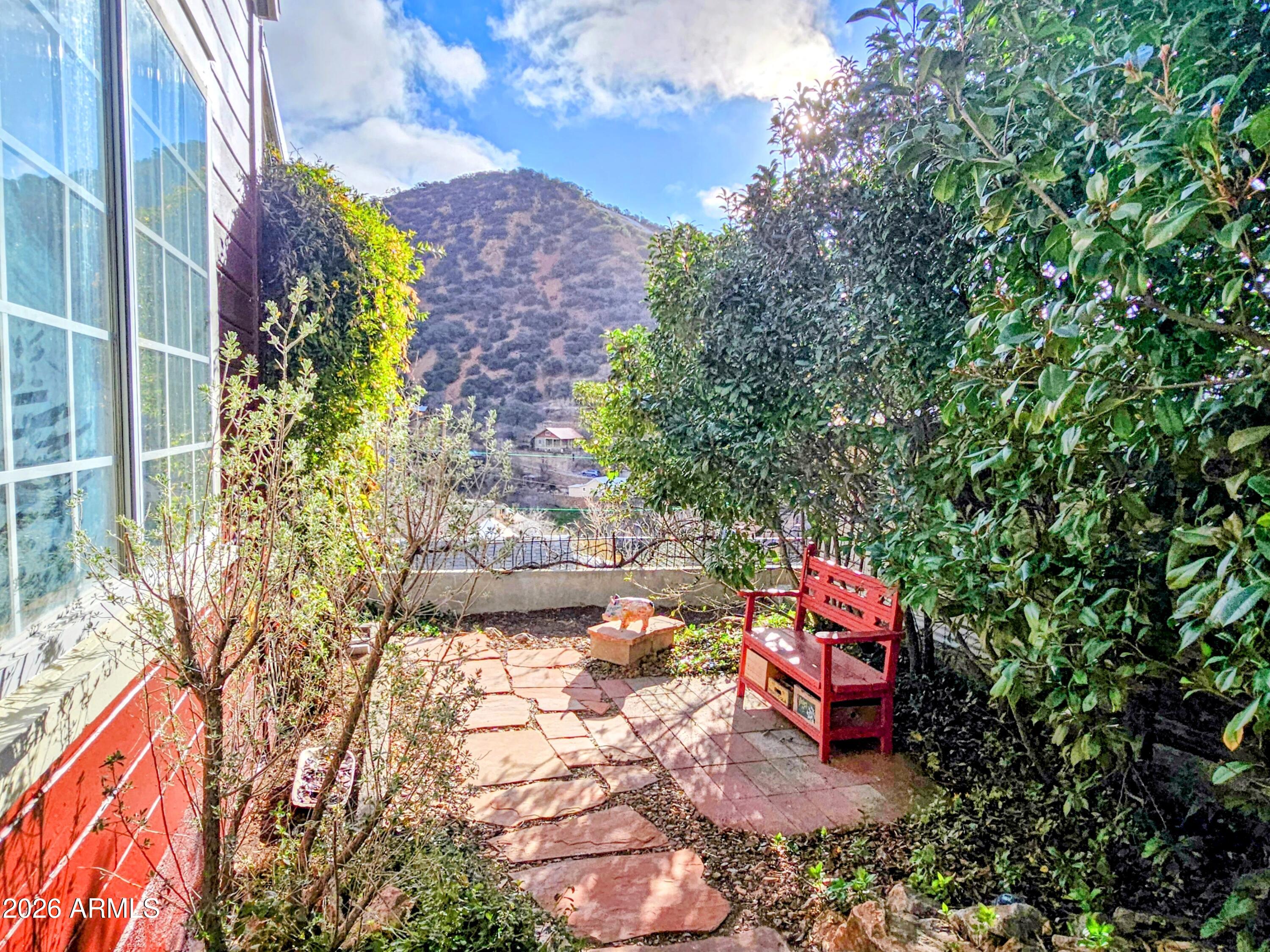 138 B Opera Drive Bisbee, AZ 85603 - Photo 30 of 34 a backyard of a house with table and chairs and potted plants