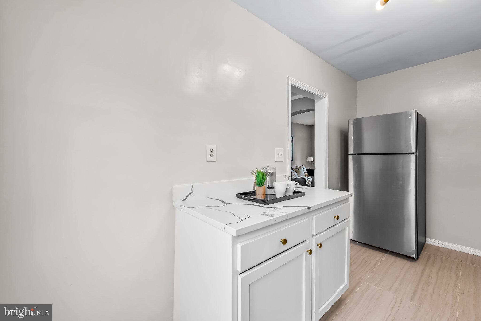 6216 Falkirk Road Baltimore, MD 21239 - Photo 12 of 27 a kitchen with a sink a refrigerator and a stove