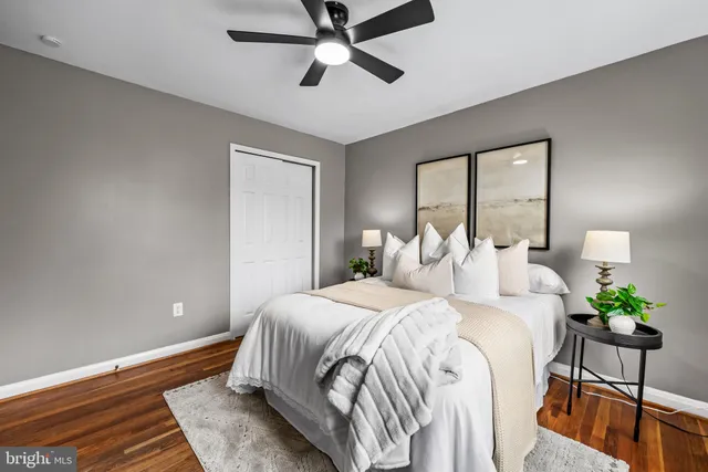 a bedroom with a large bed and a chandelier