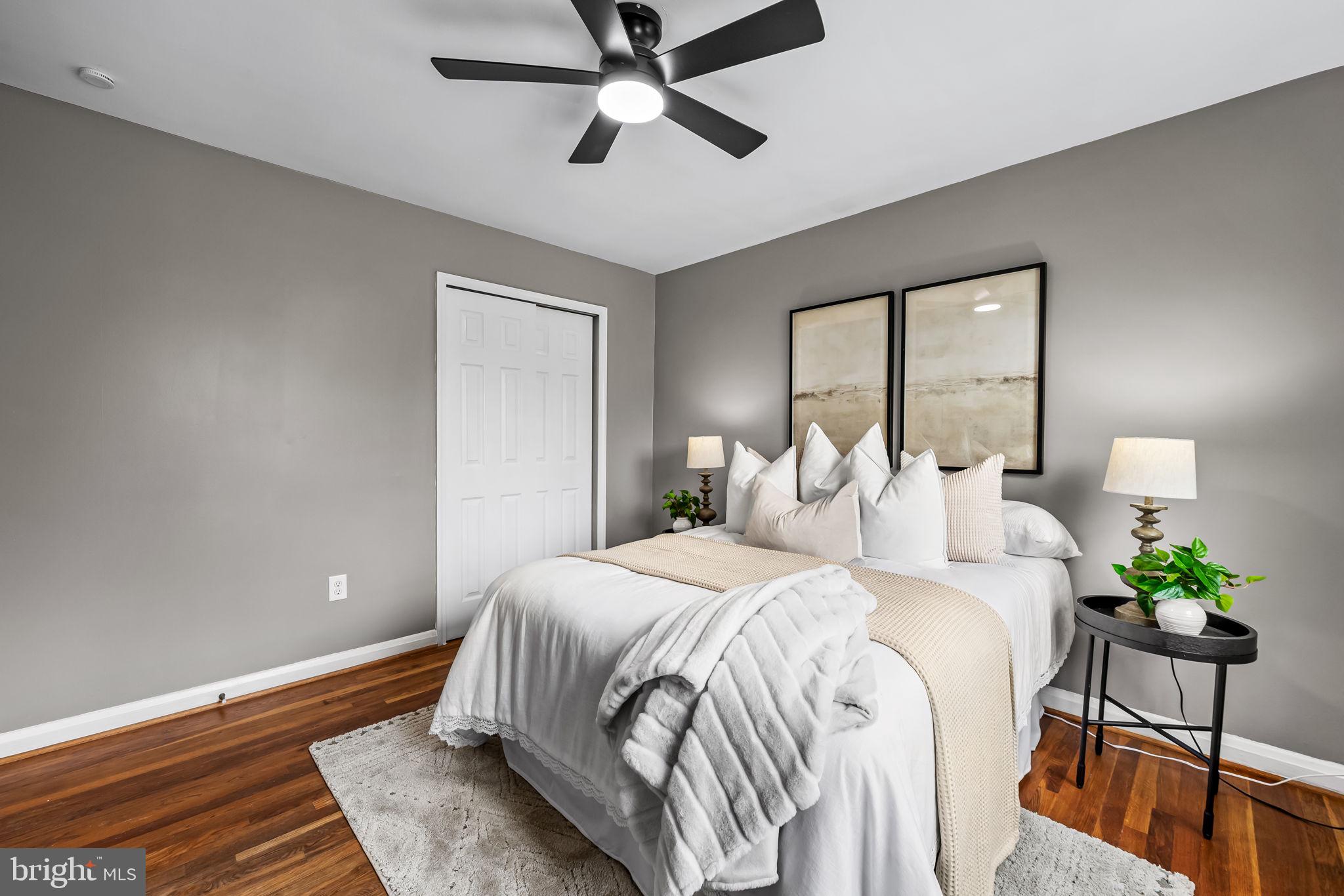 6216 Falkirk Road Baltimore, MD 21239 - Photo 15 of 27 a bedroom with a bed and a chandelier