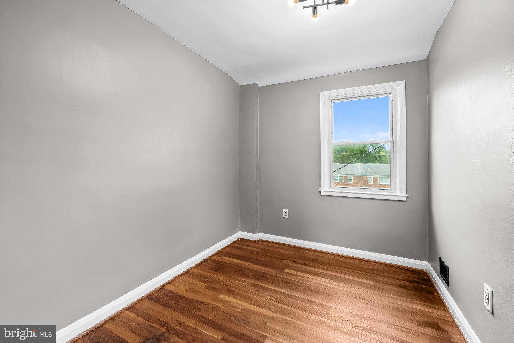 6216 Falkirk Road Baltimore, MD 21239 - Photo 21 of 27 a view of a room with wooden floor and a window