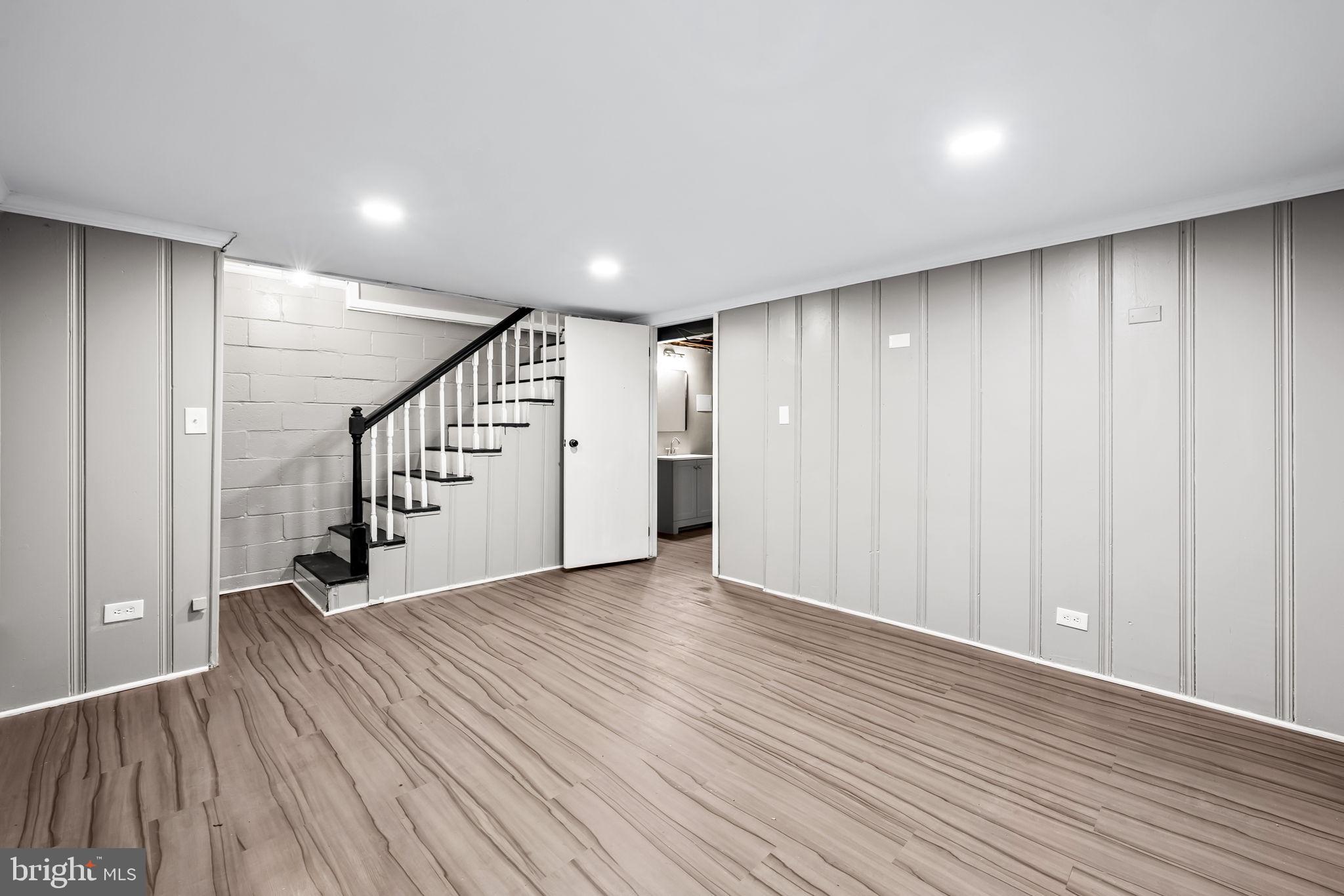 6216 Falkirk Road Baltimore, MD 21239 - Photo 24 of 27 a view of a hallway with wooden floor and staircase
