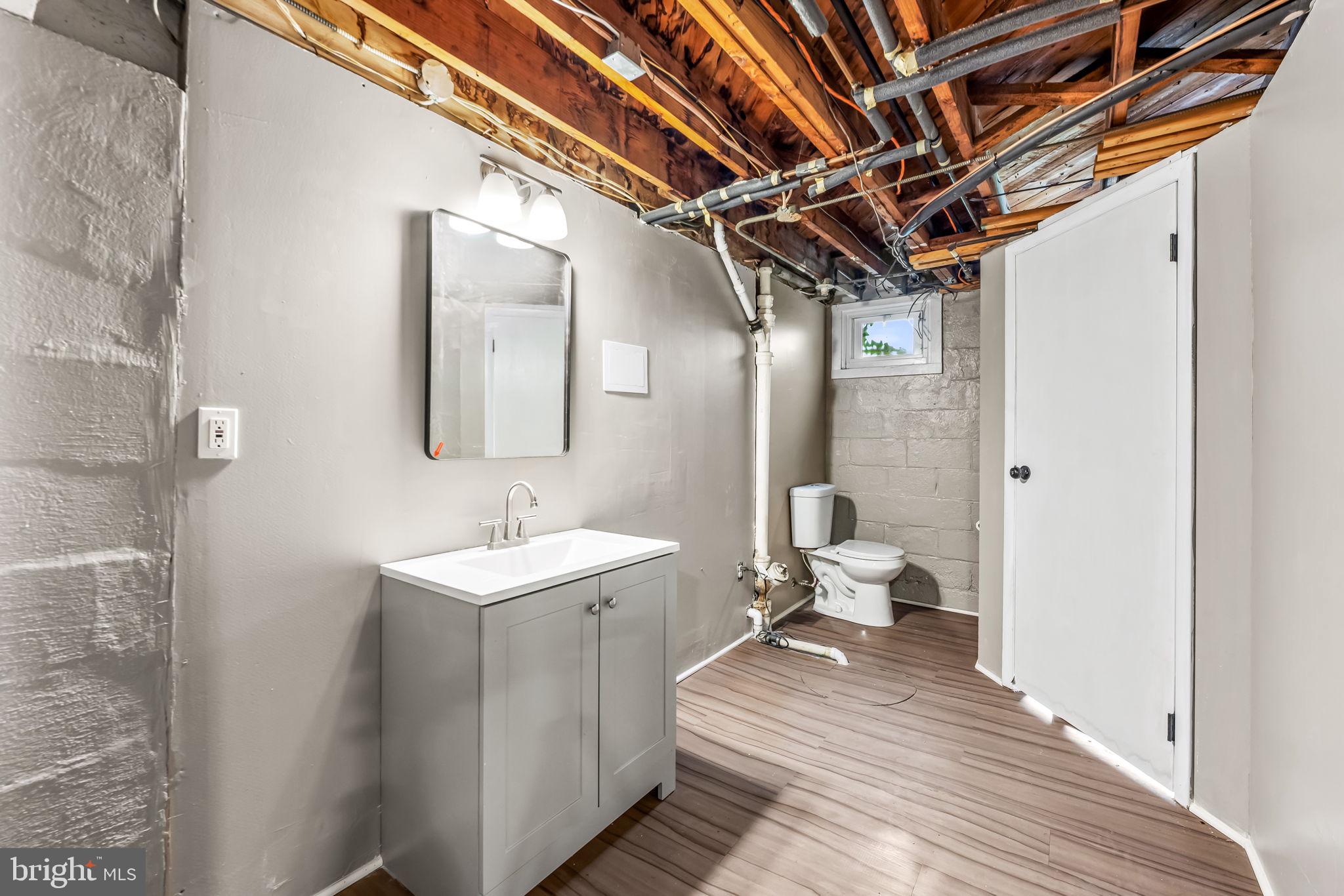 6216 Falkirk Road Baltimore, MD 21239 - Photo 25 of 27 a bathroom with a sink and a mirror