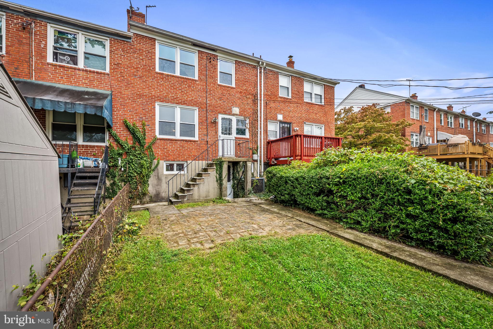 6216 Falkirk Road Baltimore, MD 21239 - Photo 26 of 27 a view of a building with a yard