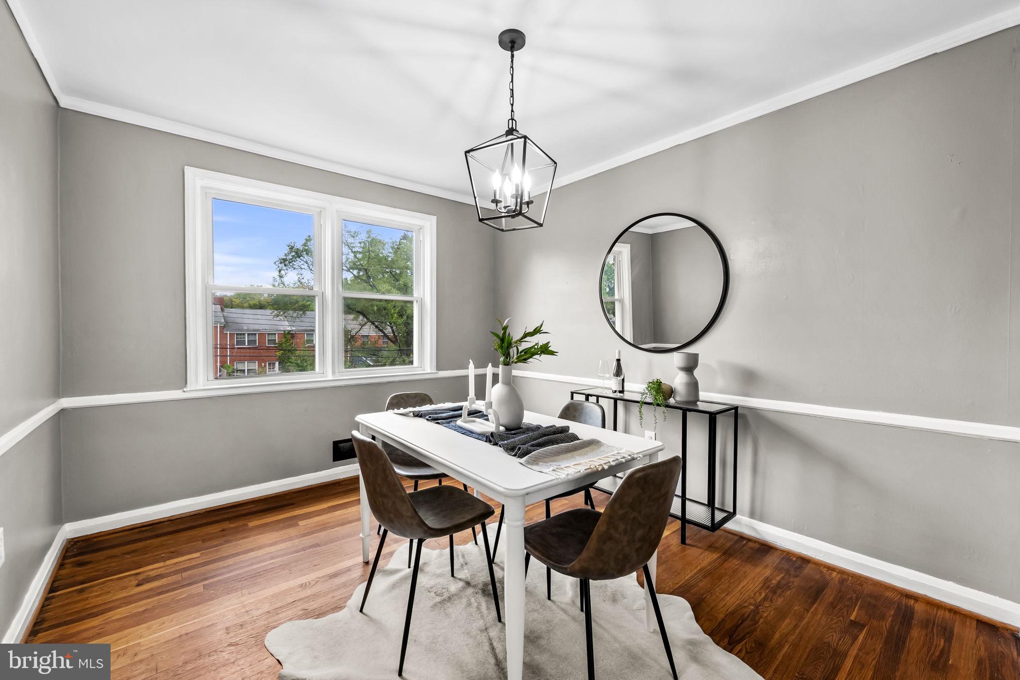 6216 Falkirk Road Baltimore, MD 21239 - Photo 6 of 27 a view of a dining room with furniture window and wooden floor