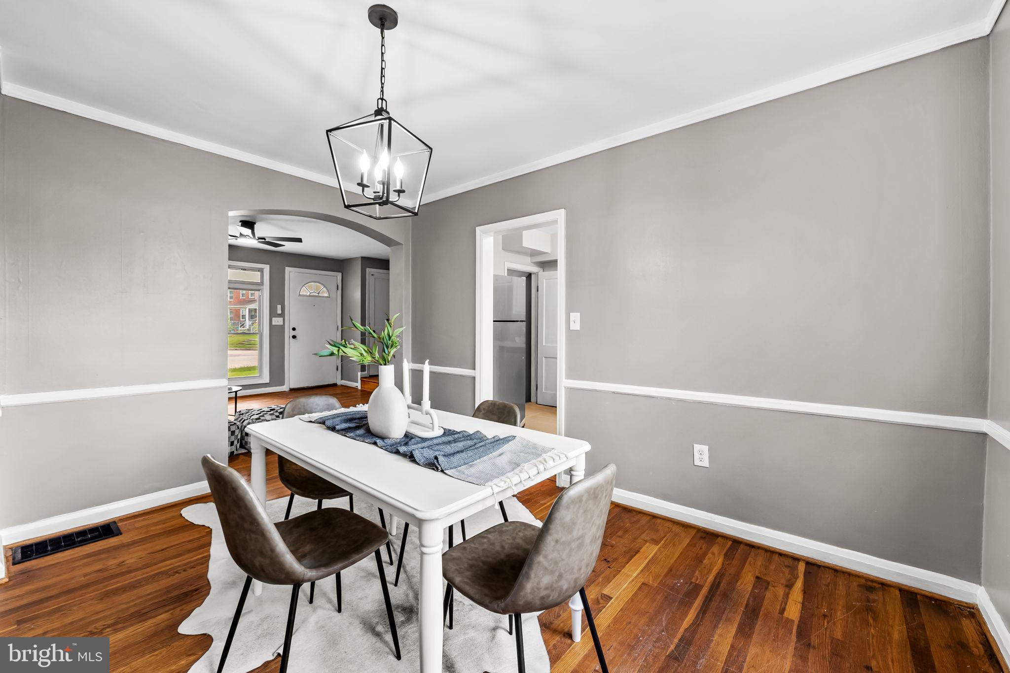 6216 Falkirk Road Baltimore, MD 21239 - Photo 7 of 27 a view of a dining room with furniture window and wooden floor