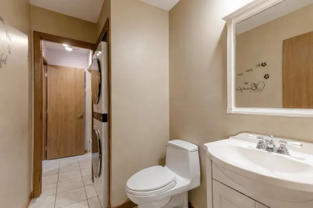 a bathroom with a toilet a sink and a mirror