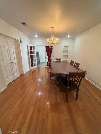 a dining room with furniture and wooden floor