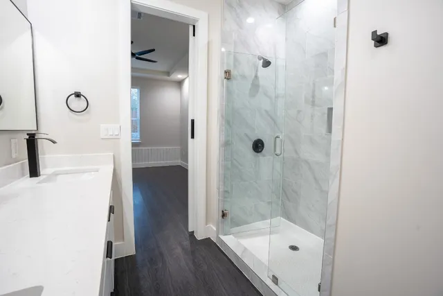 a bathroom with a glass shower door