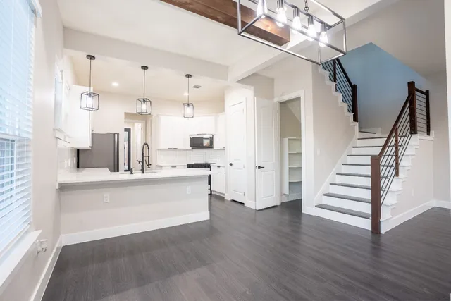 a view of kitchen with sink and wooden floor