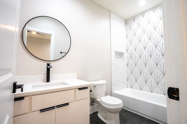 a bathroom with a sink a toilet and a mirror