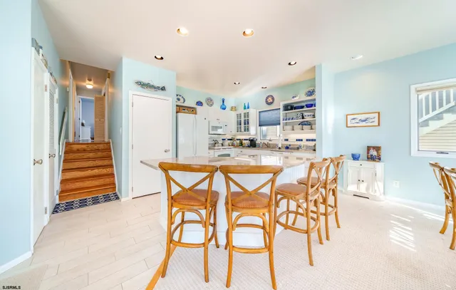 a dining area with furniture and a kitchen