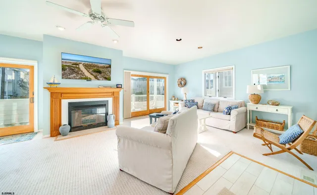 a living room with furniture a fireplace and a window