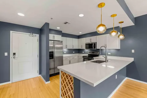 a kitchen with cabinets and stainless steel appliances