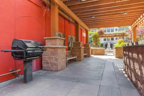 a view of a patio with a bench and chairs