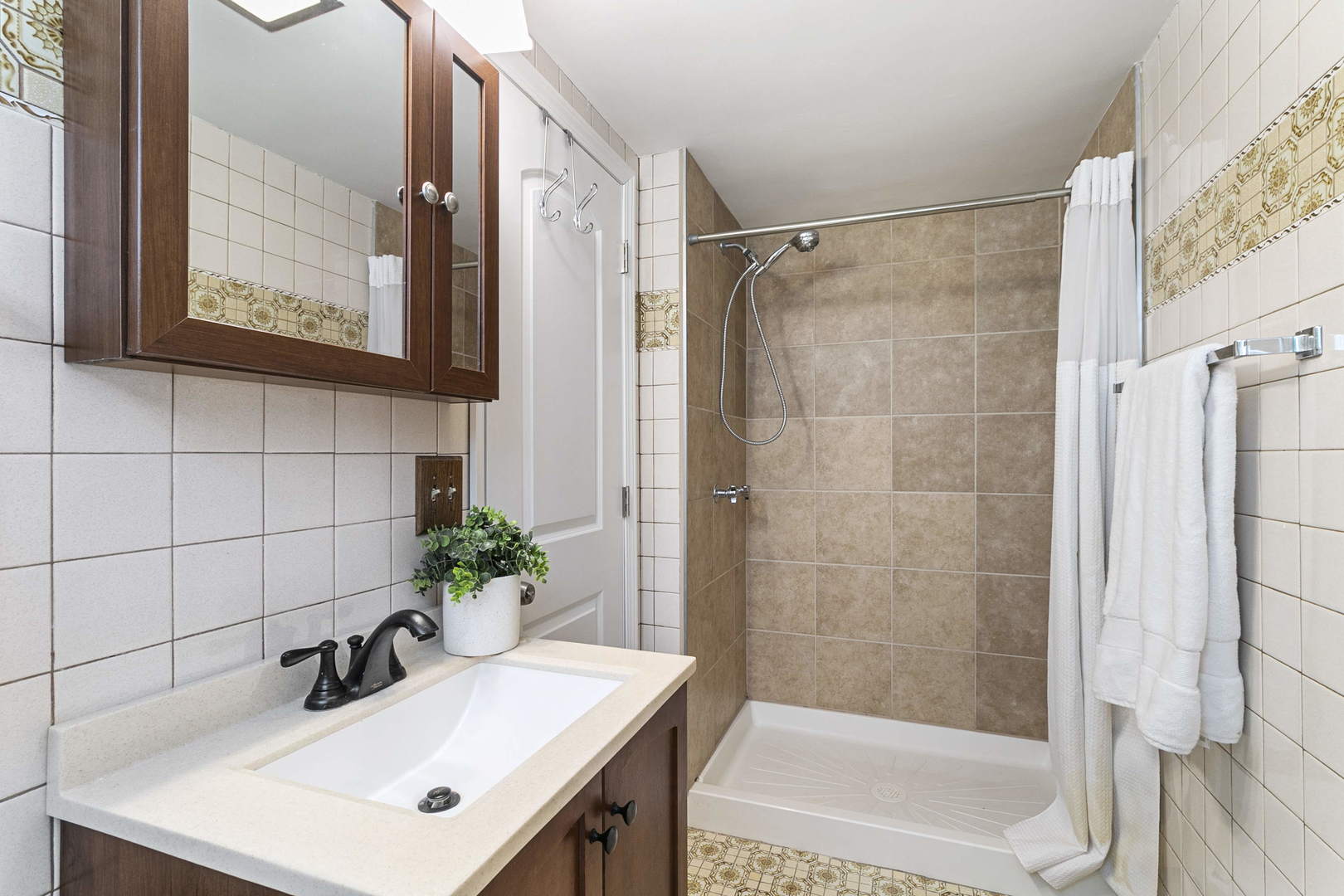 445 Uvedale Road Riverside, IL 60546 - Photo 13 of 26 a bathroom with a sink a mirror and a shower
