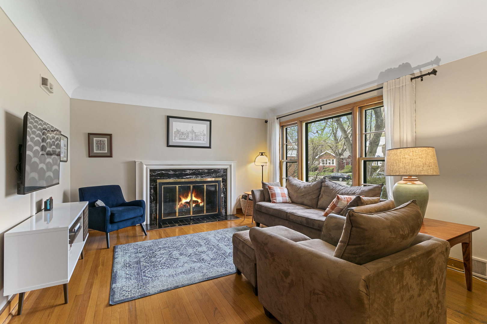 445 Uvedale Road Riverside, IL 60546 - Photo 5 of 26 a living room with furniture and a fireplace