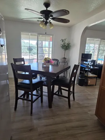 wooden floor in a hall with white walls