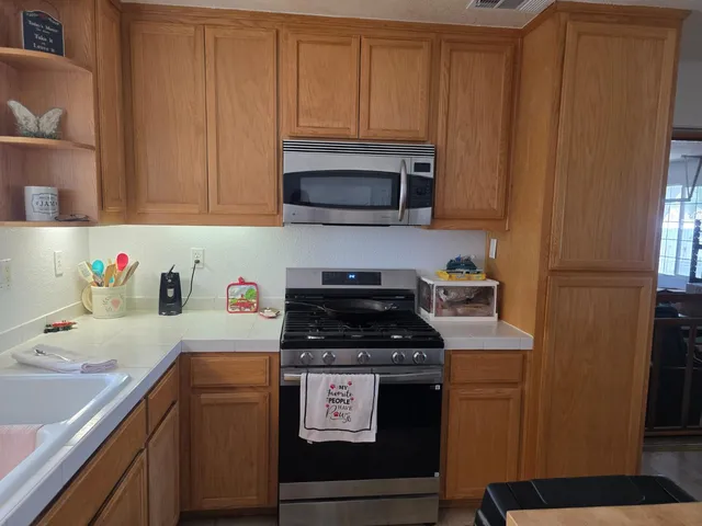 a kitchen with a sink cabinets and a window