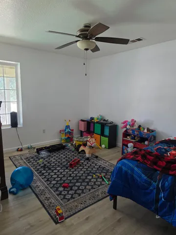 a white toilet sitting next to a bathroom sink and a shower