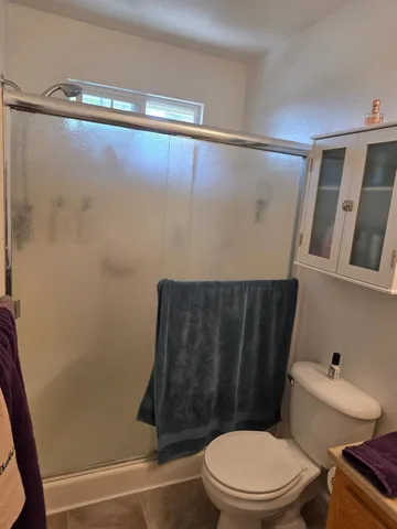 a bedroom with a bed and a mirror on the dresser