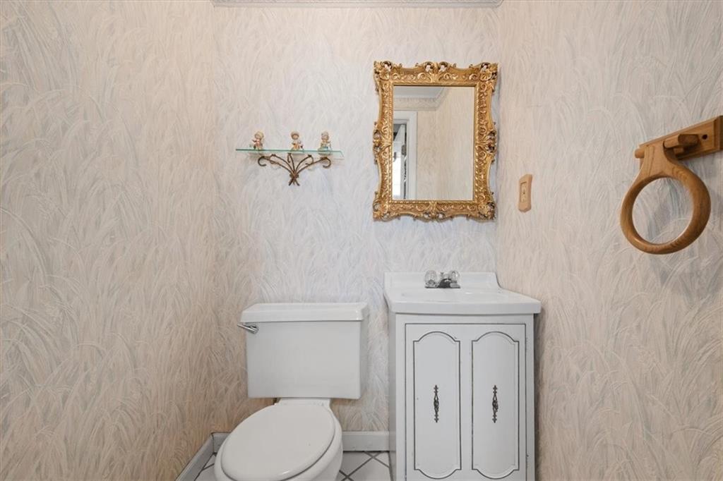 701 Wible Run Road Pittsburgh, PA 15209 - Photo 27 of 33 a bathroom with a toilet mirror vanity and a sink