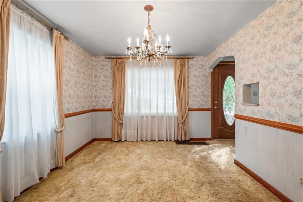 701 Wible Run Road Pittsburgh, PA 15209 - Photo 6 of 33 a view of a livingroom with a chandelier curtains and large windows