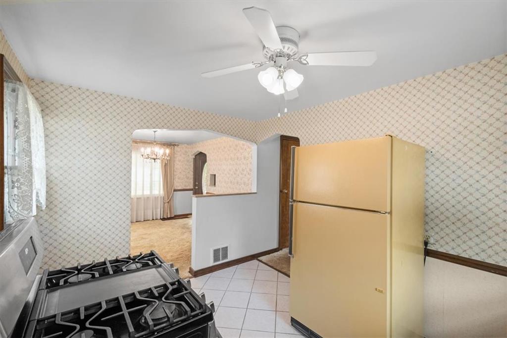 701 Wible Run Road Pittsburgh, PA 15209 - Photo 8 of 33 a kitchen with a refrigerator and a stove