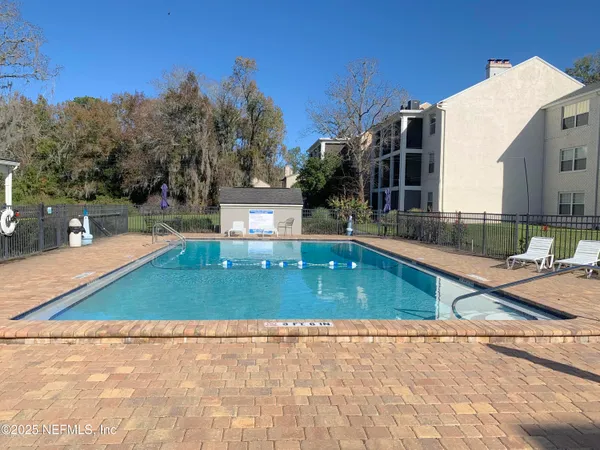 a view of a swimming pool with a patio