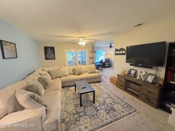 a living room with furniture and a flat screen tv