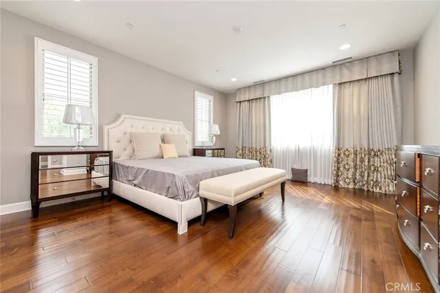 a bedroom with a bed and a large window