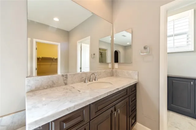 a bathroom with a granite countertop sink mirror and double