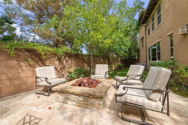 a view of a patio with a table and chairs under an umbrella
